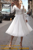 Runhufu Simple Short Wedding Dress Long Sleeve Tulle Tea-Length Bridal Party Gown with Belt V-Neck A-Line Button Custom Made